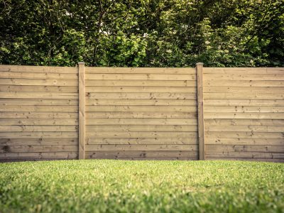 Wooden fence on a green lawn